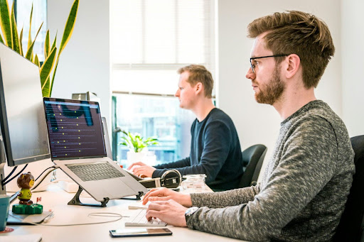 men working on laptop